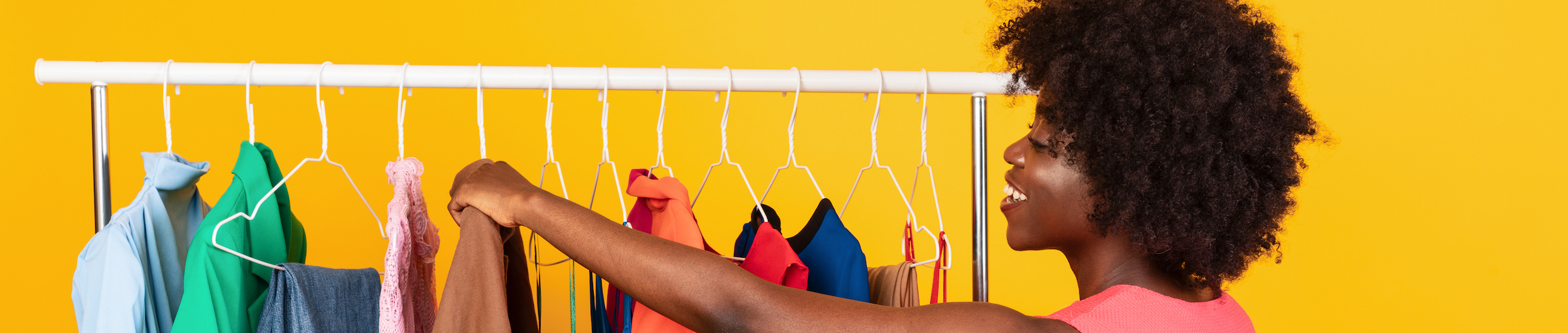 Woman hanging clothes for GarageSaleIt
